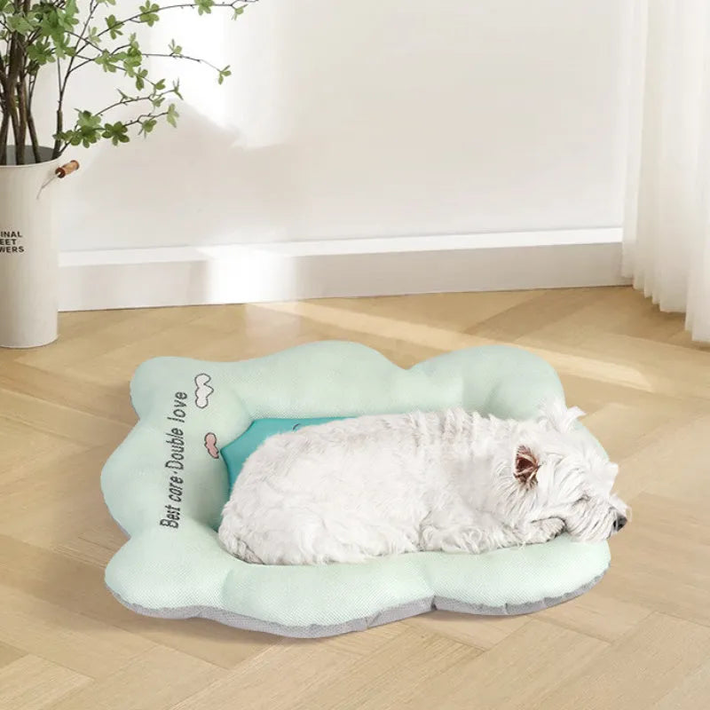 Green and pink pet cooling mats for dogs and cats in four different sizes on a wooden floor.