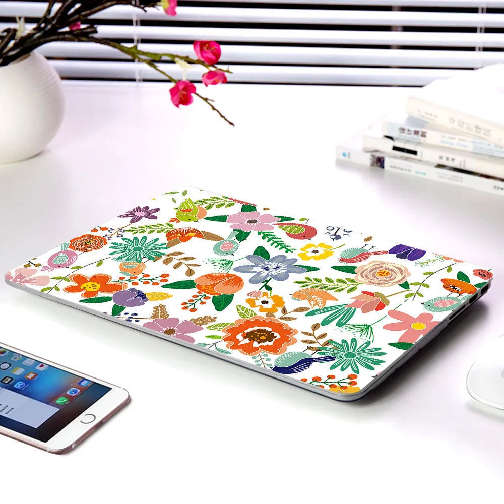 Plastic protective shell with floral pattern for Apple MacBook laptop showing sampling flower design
