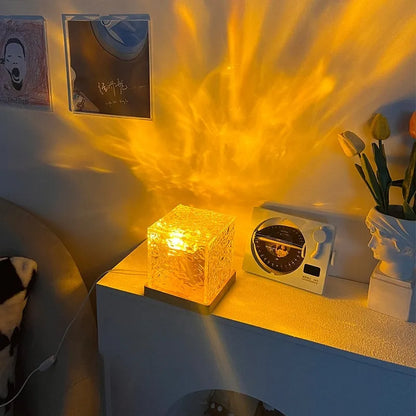 LED water ripple projection night light with remote control on wooden base showing colourful light patterns