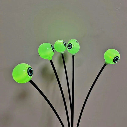 Solar-powered Halloween string lights with detailed eyeball design for outdoor garden decoration