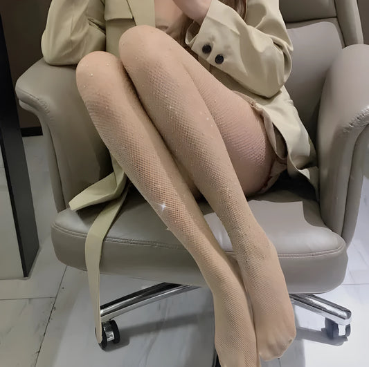 Women's fishnet stockings with diamond mesh pattern in skin colour, laid flat
