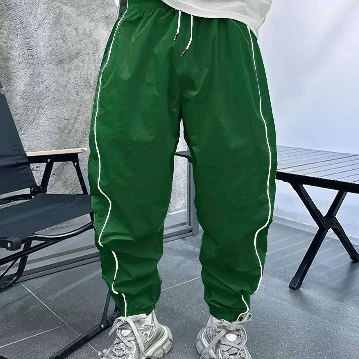 Men's bamboo fibre cropped sports trousers in army green colour showing loose fit and elastic waistband