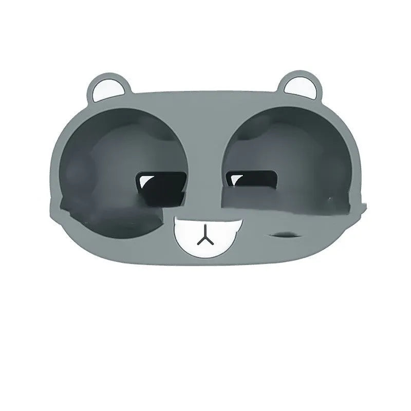 Flexible grey silicone car cup holder insert with a raised cartoon animal design for the centre console.
