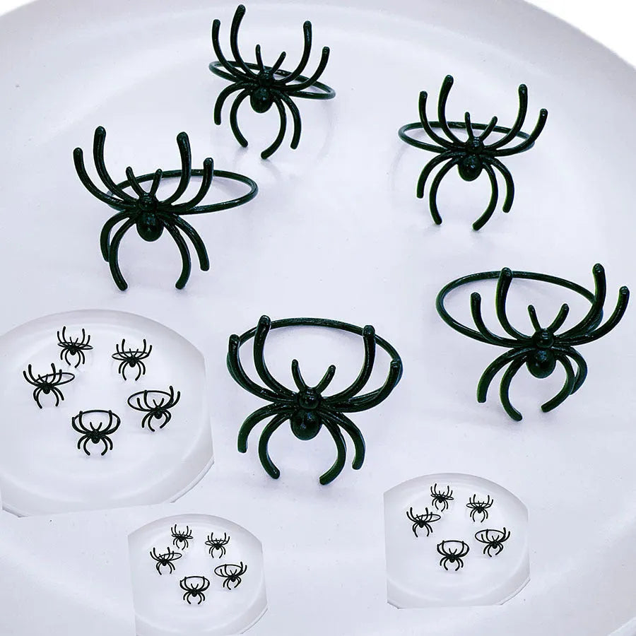 Six black spider-shaped alloy napkin rings with electrophoresis coating for Halloween table settings