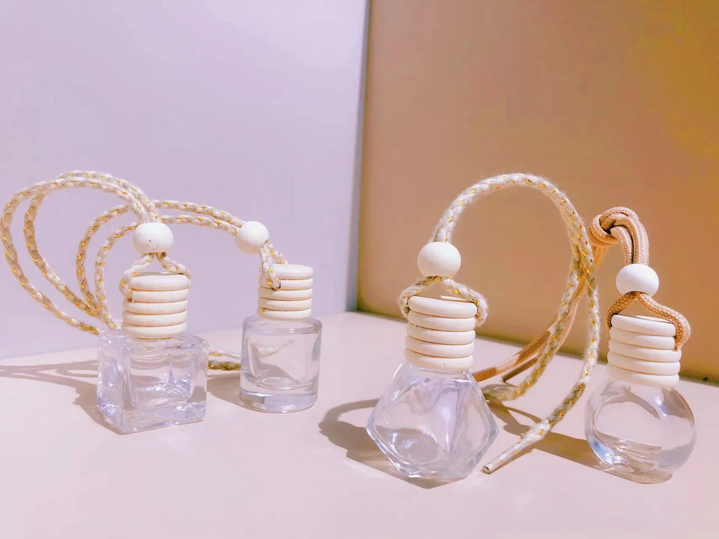Car perfume pendant in four glass bottle styles: cylinder, diamond, flat drum, and square