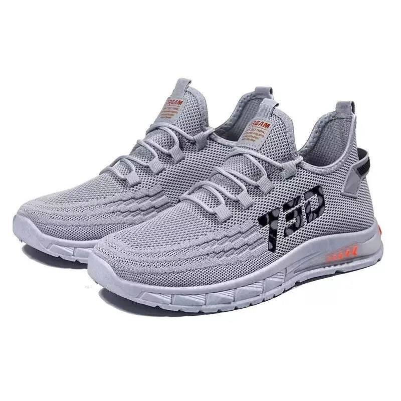 Low-top black mesh sneakers with a flat plastic sole and shallow cut design on a white background.