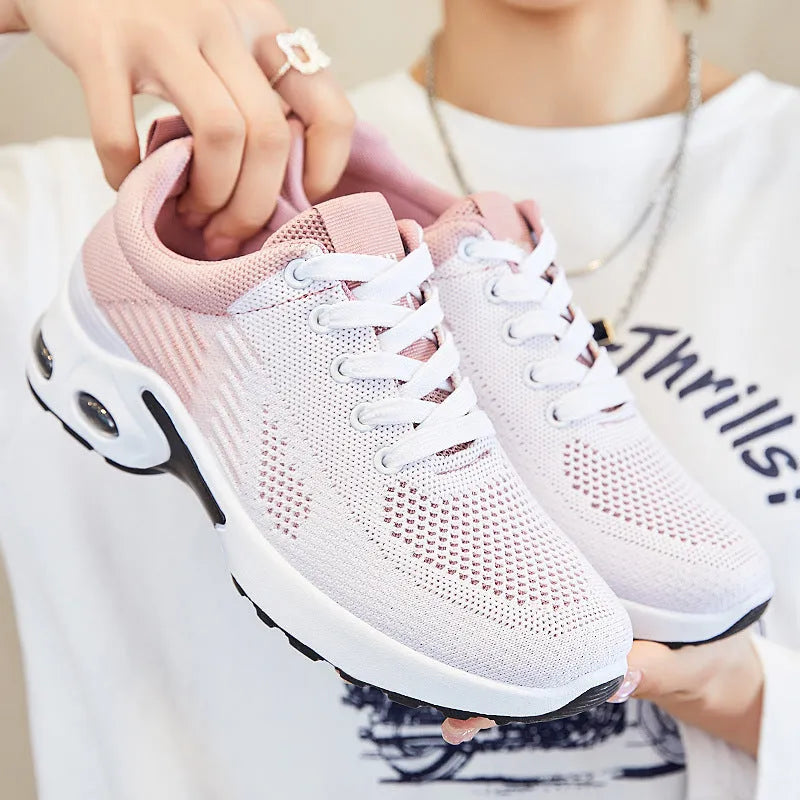 Women's striped Flyknit casual running shoes in pink, shown with a flat PVC sole and front lace-up closure.