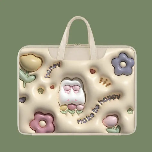 PU leather inflatable laptop bag with strap, shown in a cartoon pattern design, hanging from a suitcase handle.