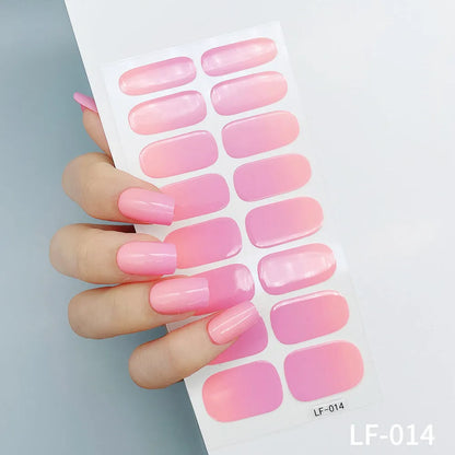 Sheet of 16 small design nail art stickers including cross, rose, tulip and marble patterns.