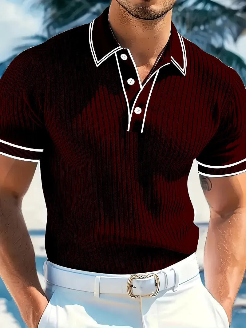 A man wearing a loose-fit, striped, short-sleeved polo shirt in a dark colour.