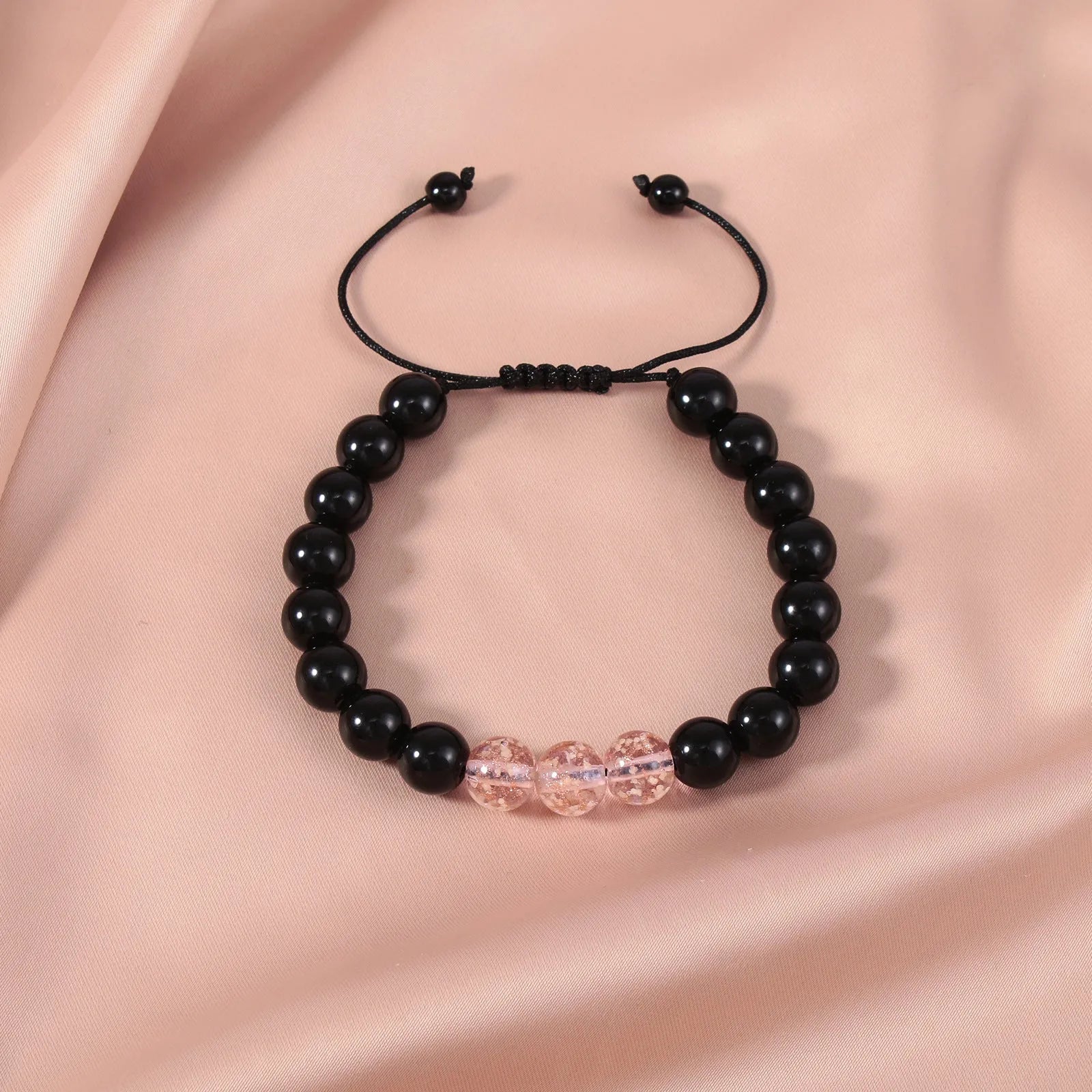 Adjustable bracelet with luminous geometric glass beads in six colour options on a wrist