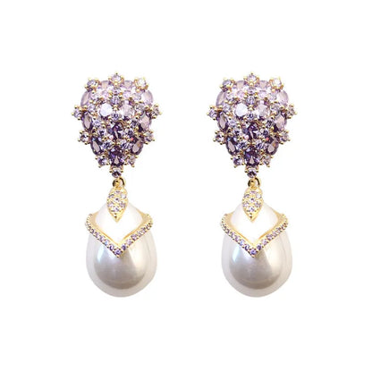 Women's drop-shaped freshwater pearl earrings with zircon inlay on 18K gold-plated settings.