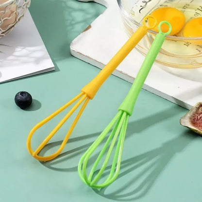 Mini manual eggbeater in green or yellow for efficient baking