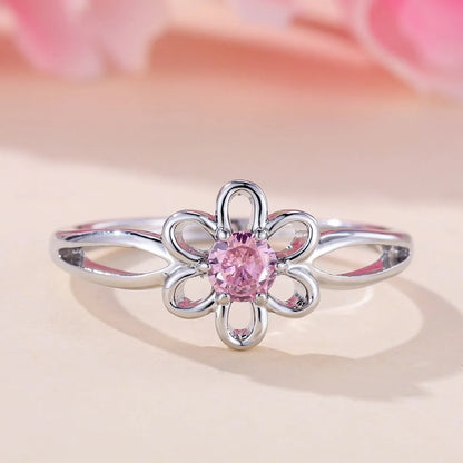Women's hollow flower design fashion ring in electroplated copper with a platinum pink diamond finish.