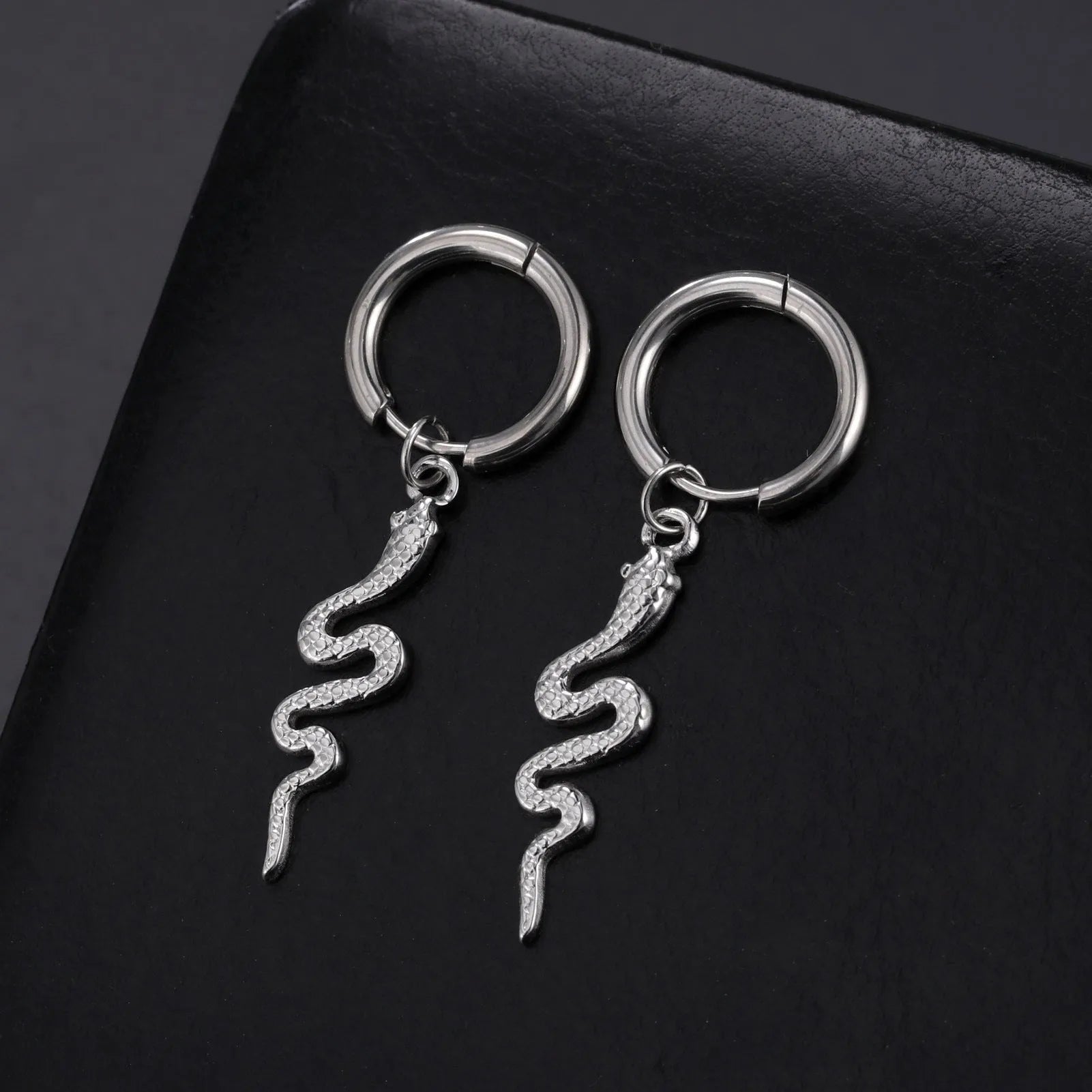 Gold coloured snake-shaped vintage clip-on earrings made from stainless steel.