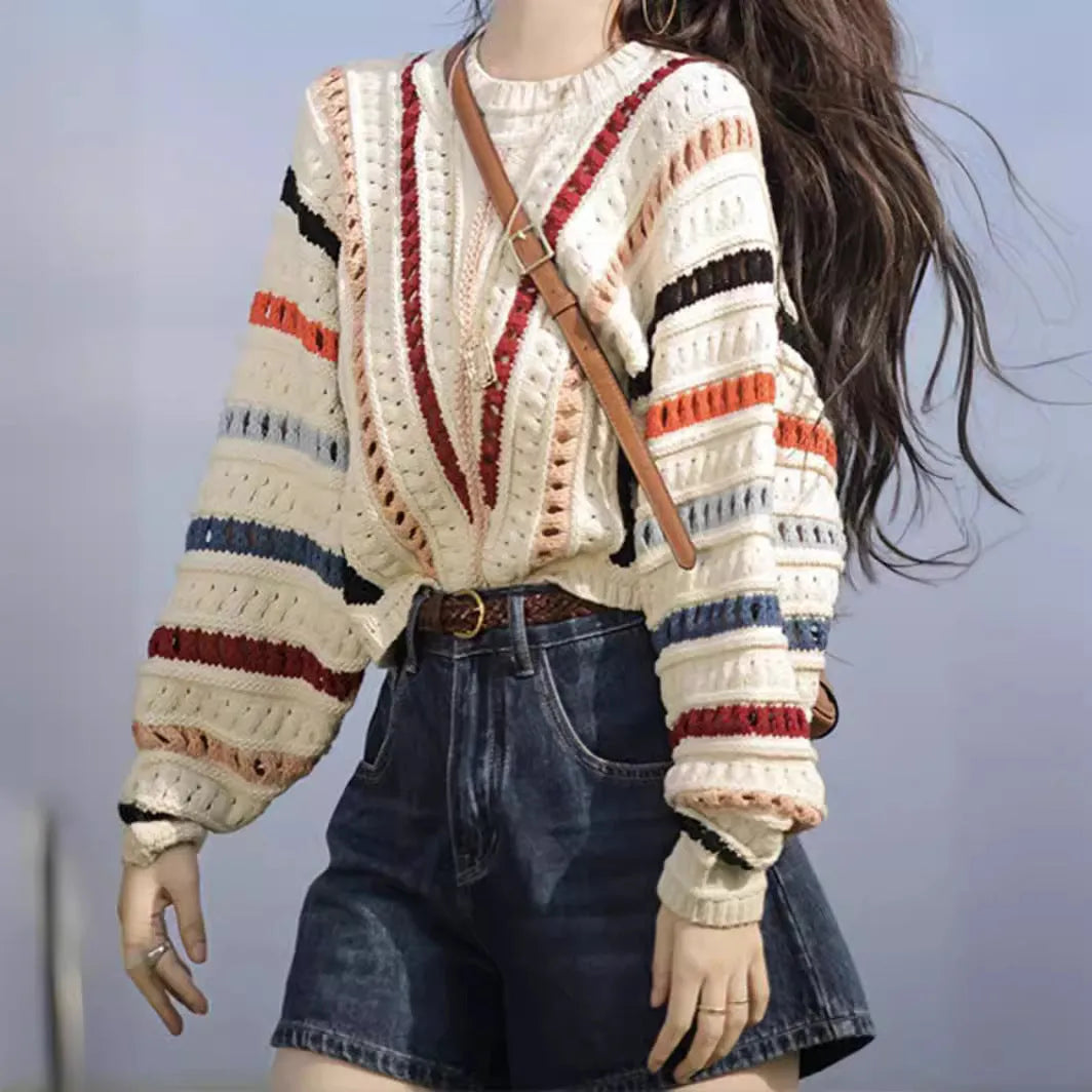 Rainbow striped batwing sleeve hollow knit sweater with round neck, shown in loose fit on model