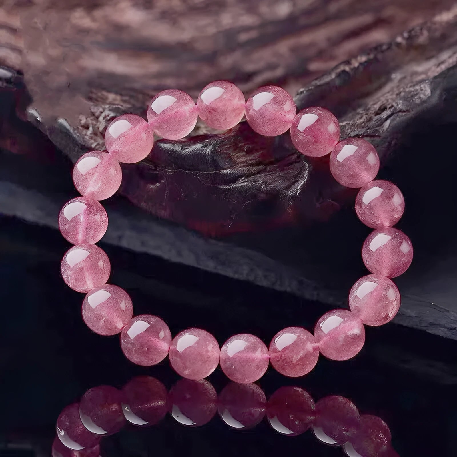 Women's strawberry quartz crystal bracelet with mixed 6mm, 8mm, and 10mm polished beads.