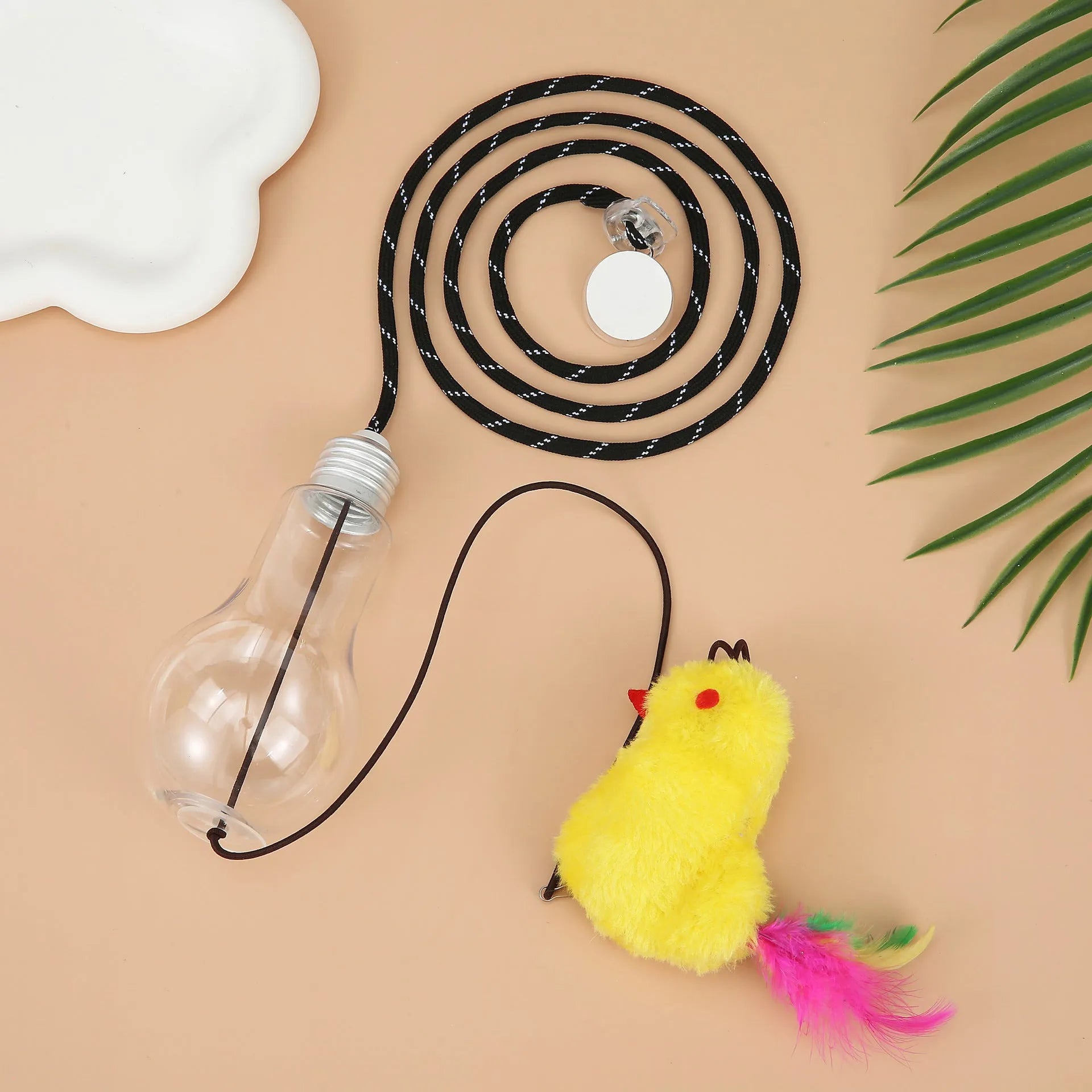 Grey and yellow interactive cat toy hanging on door frame with retractable elastic rope and treat dispenser