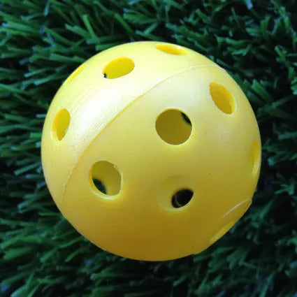 Hollow plastic golf practice balls in various colors for indoor use