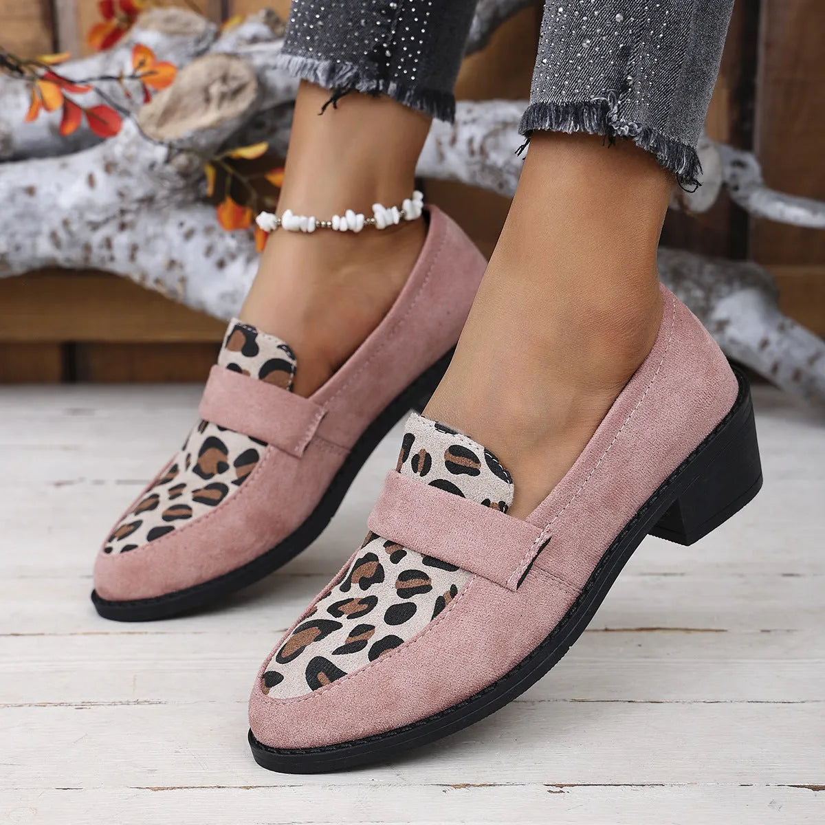 Leopard print slip-on suede pump shoe with chunky mid heel and pointed toe on a rubber sole.