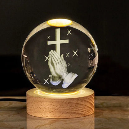 White crystal ball ornament with solid wood warm light base, showing purity engravings like Cross and Maria for desk decor