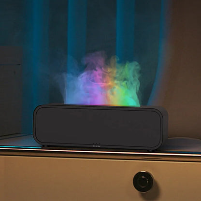 Black Flame Dynamic Aroma Diffuser with colour-changing lights and remote control on a table.