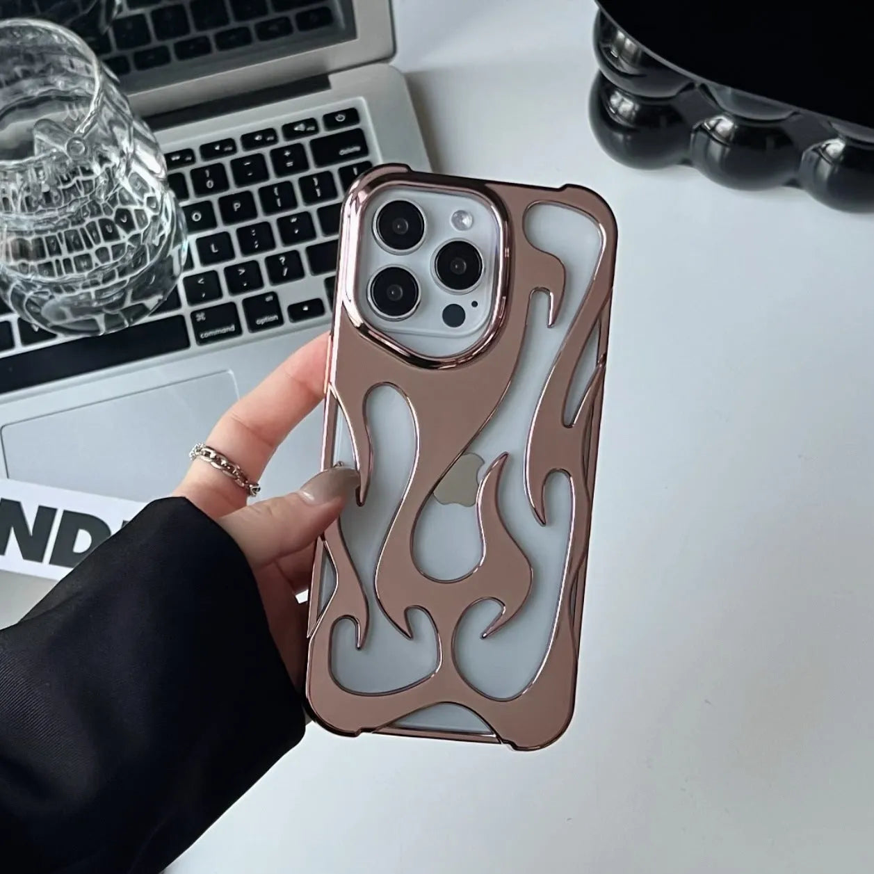 Electroplated hollow flame pattern phone case in silver plated finish on Apple iPhone, showing heat dissipation design and TPU soft shell