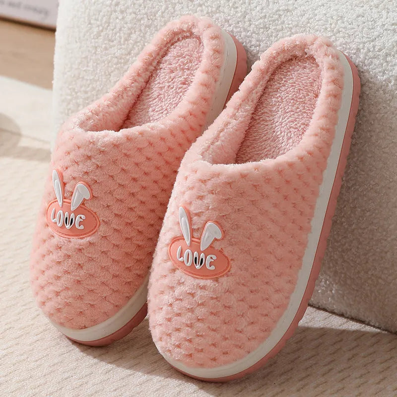 Women's plush rabbit plaid design winter slippers with a thick light-coloured rubber sole.
