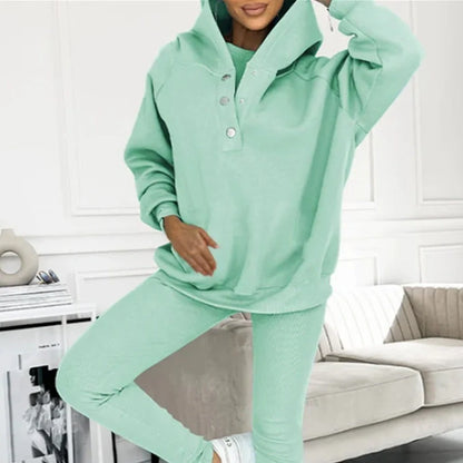 Women's 3-piece sports suit featuring a hooded sweatshirt with pockets and slim trousers