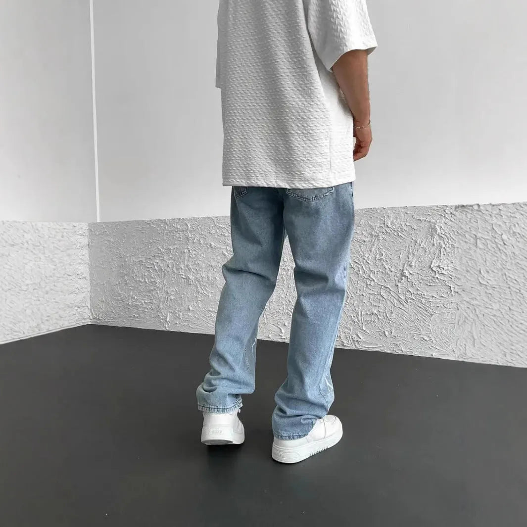 Men's blue straight-leg denim trousers with mid-waist design and zipper fly closure