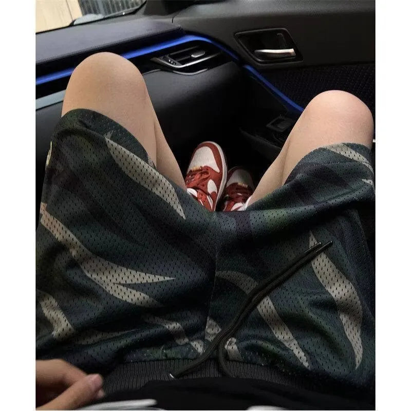 Men's straight-leg camouflage shorts in a cotton-polyester blend fabric on a neutral background.