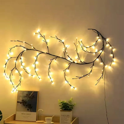 Flexible DIY willow vine LED light garland with warm white lights shaped on a wall.