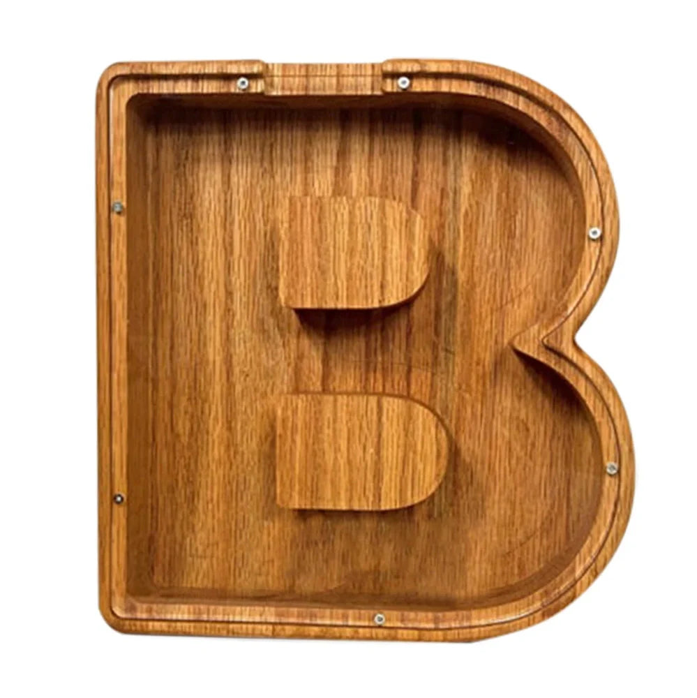 Handmade wooden letter piggy bank with personalised initial, showing 15cm height and 5cm coin slot for UK coins