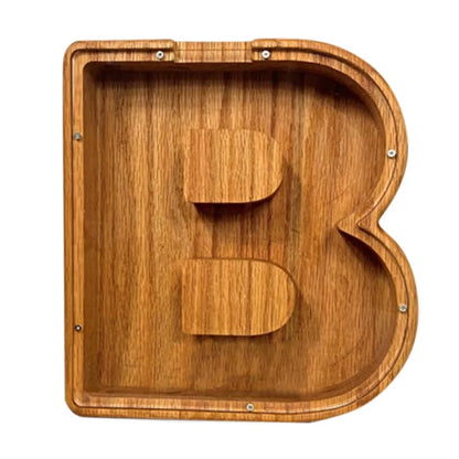 Handmade wooden letter piggy bank with personalised initial, showing 15cm height and 5cm coin slot for UK coins