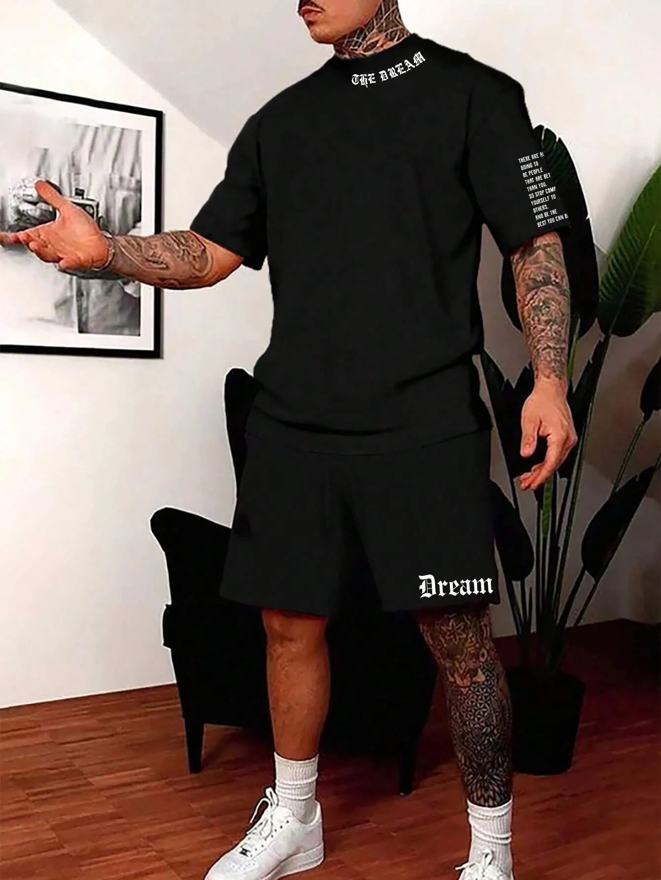 Man wearing a printed short-sleeve top and matching shorts from the sports style two-piece set.