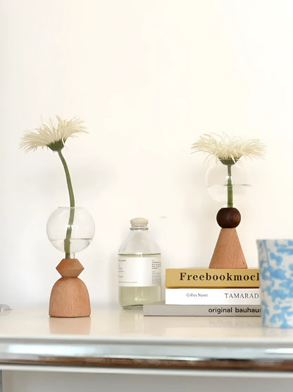 Geometric clear glass bubble vase on wooden base showing conical and arc bottom style options