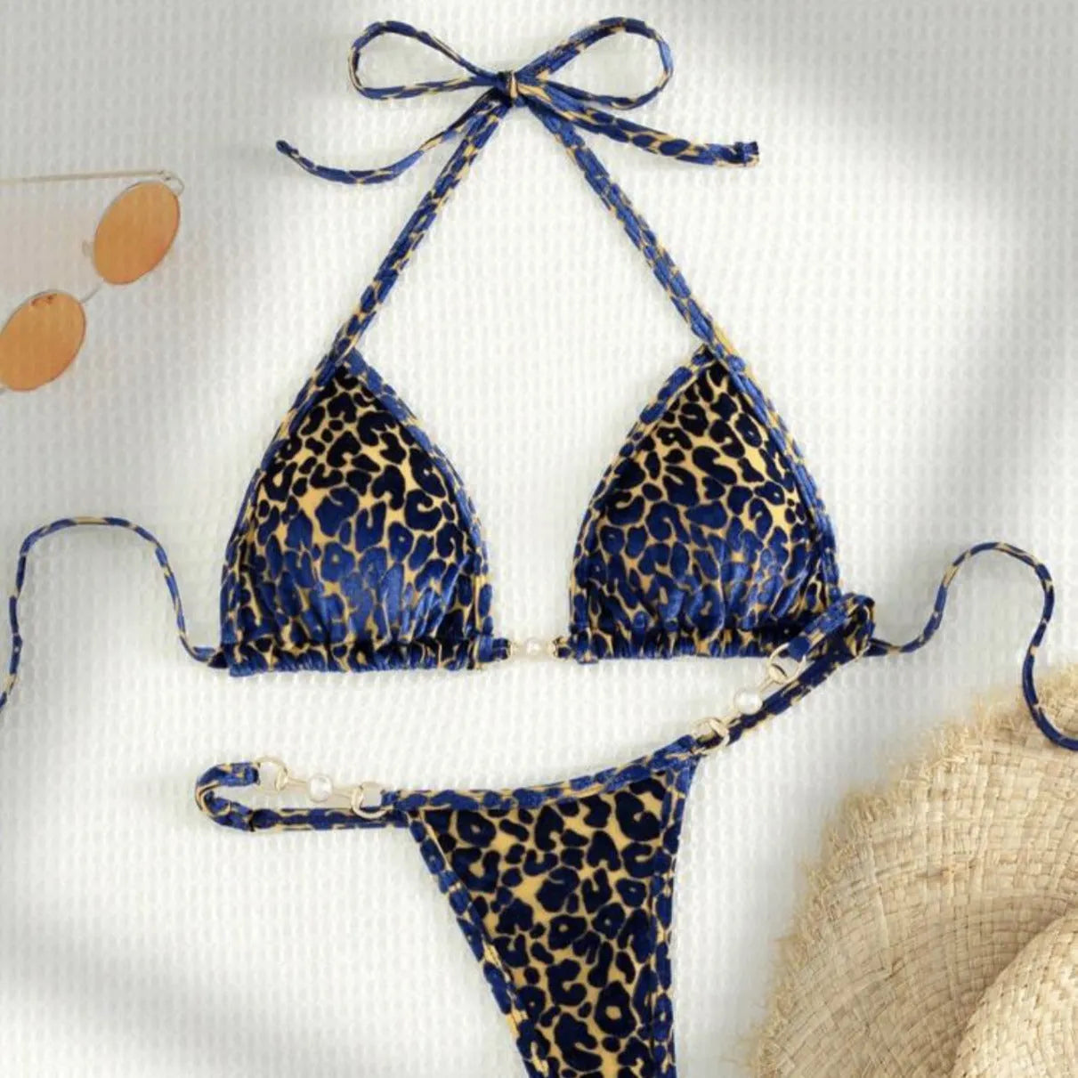 Women's blue leopard print T-shaped bikini set for swimming on a mannequin.