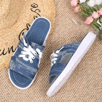 Blue Roman-style women's flat canvas slippers with a cloth upper and rubber sole.