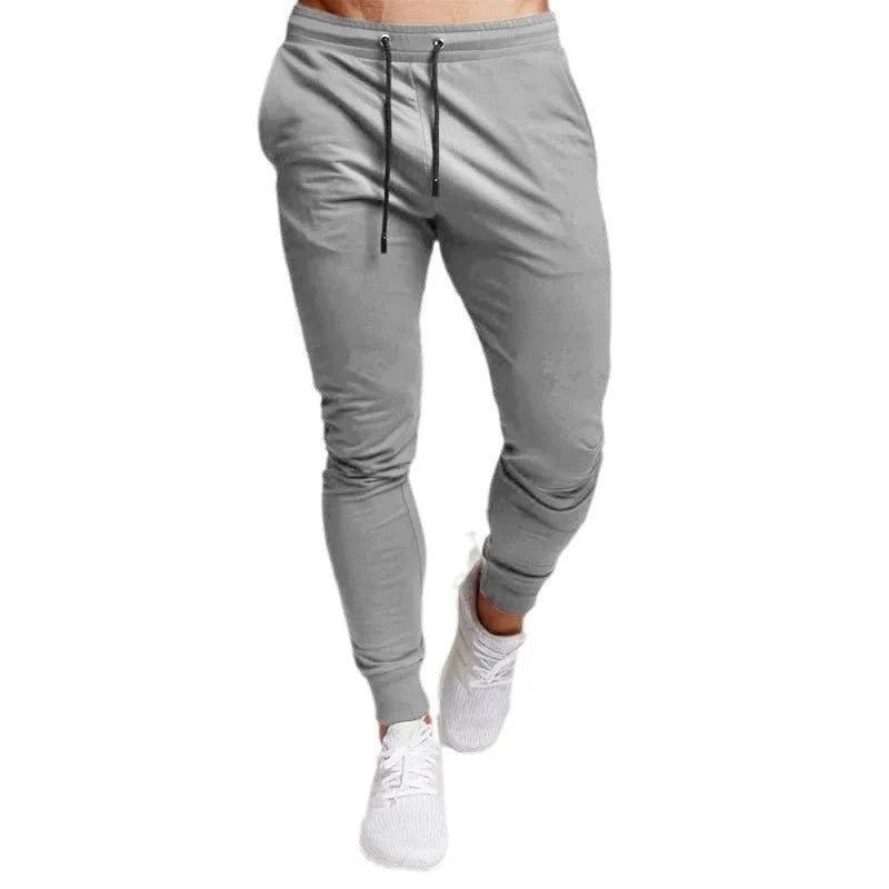 Men's cotton skinny sports trousers with drawstring and belt, available in five solid colours