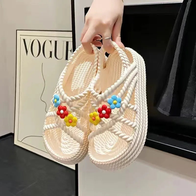Women's beige PVC sandals with a sunflower pattern and round toe on a non-slip sole.