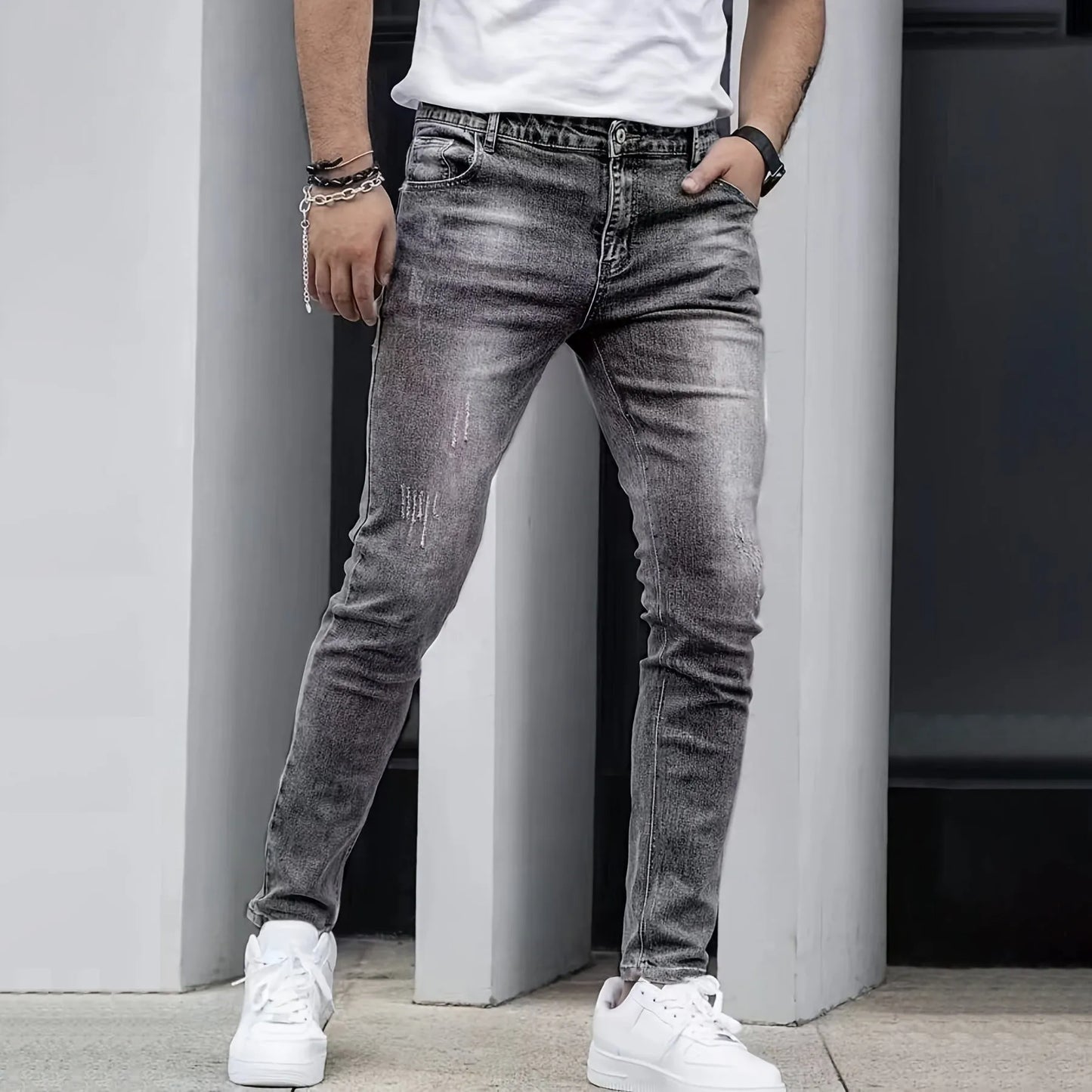 Men's black stretch jeans with straight leg skinny fit showing zipper fly and mid-rise waist