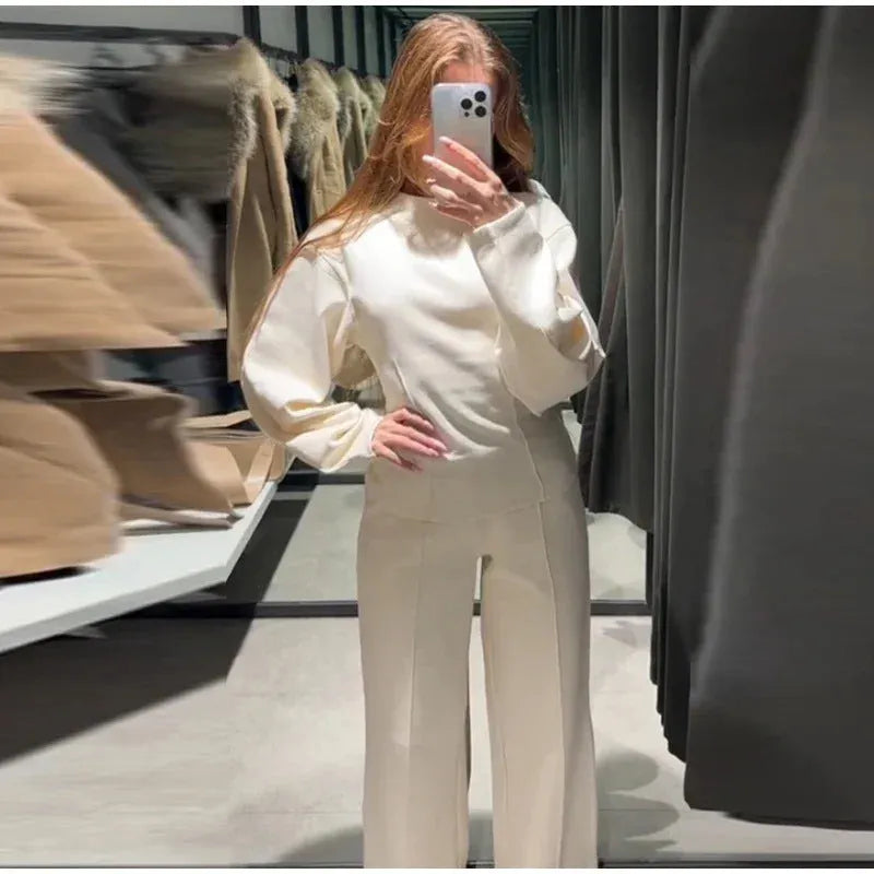 Women's black fleece tracksuit set featuring a pleated long sleeve top and wide leg trousers
