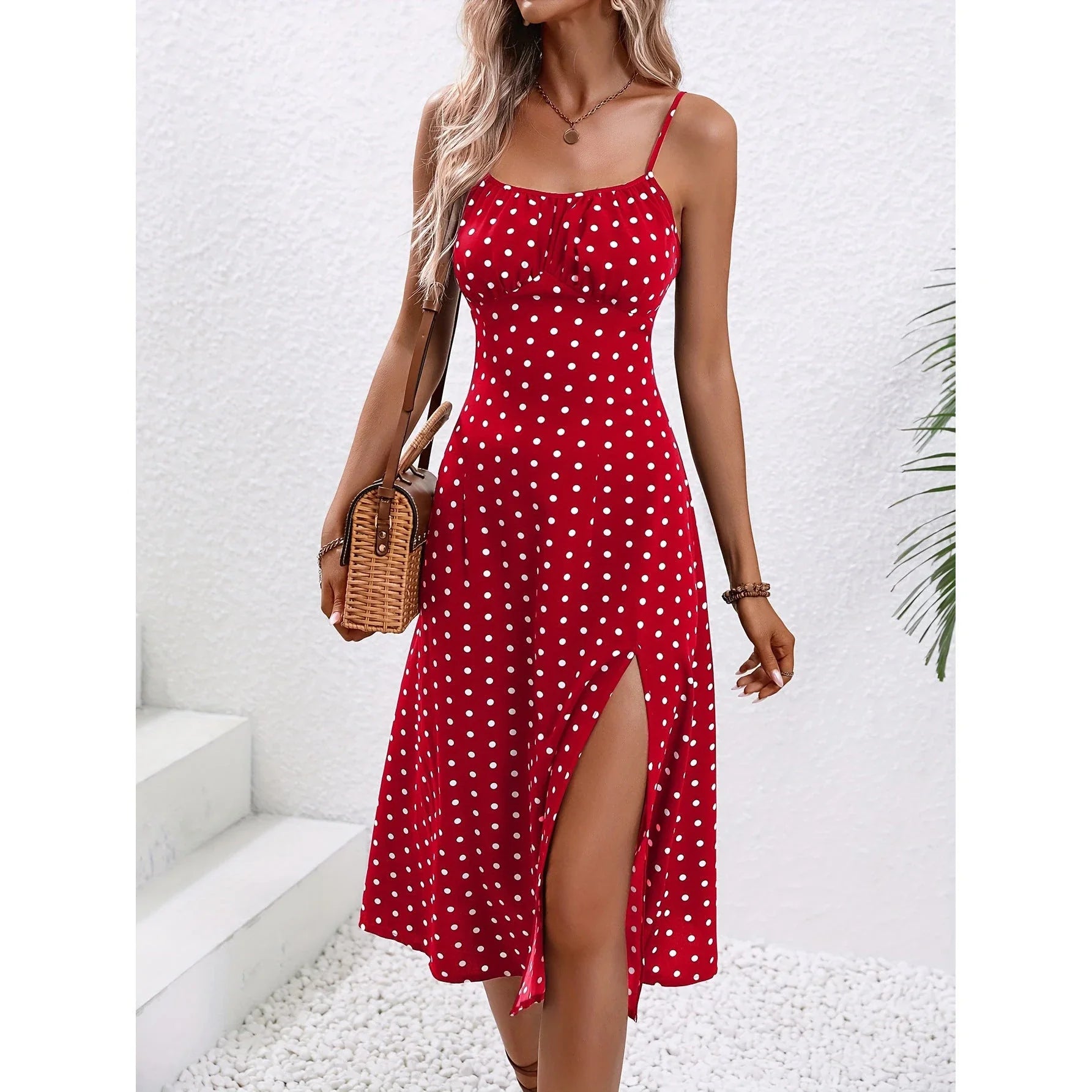 Stylish polka dot suspender dress with adjustable straps, side slit, and available in multiple vibrant colors