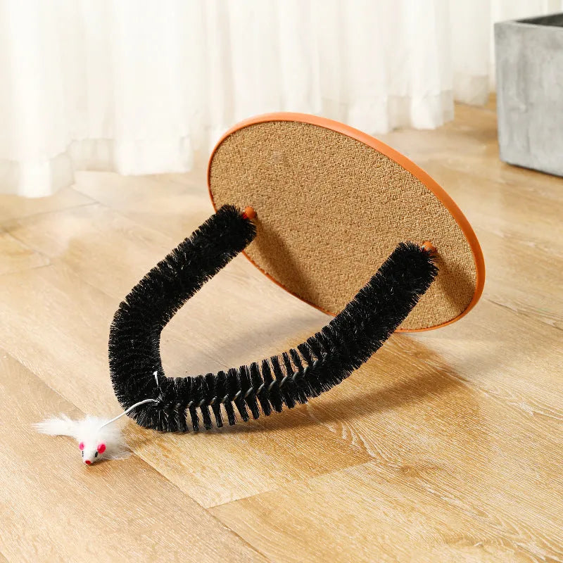 Black arch-shaped cat grooming brush with scratching fibre and an attached mouse toy on a non-slip base
