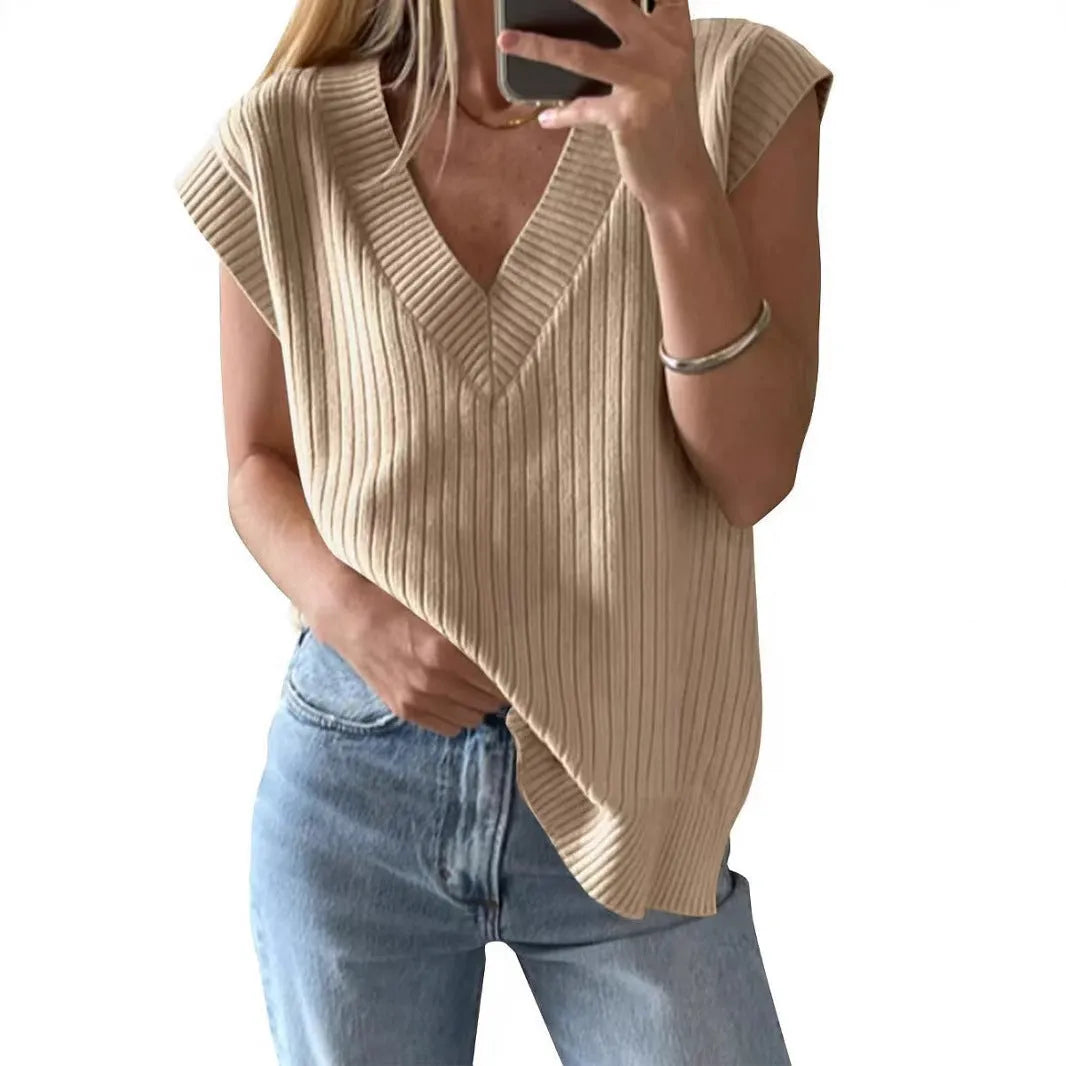 Camel coloured loose v-neck sleeveless vest with a striped pattern on a hanger.