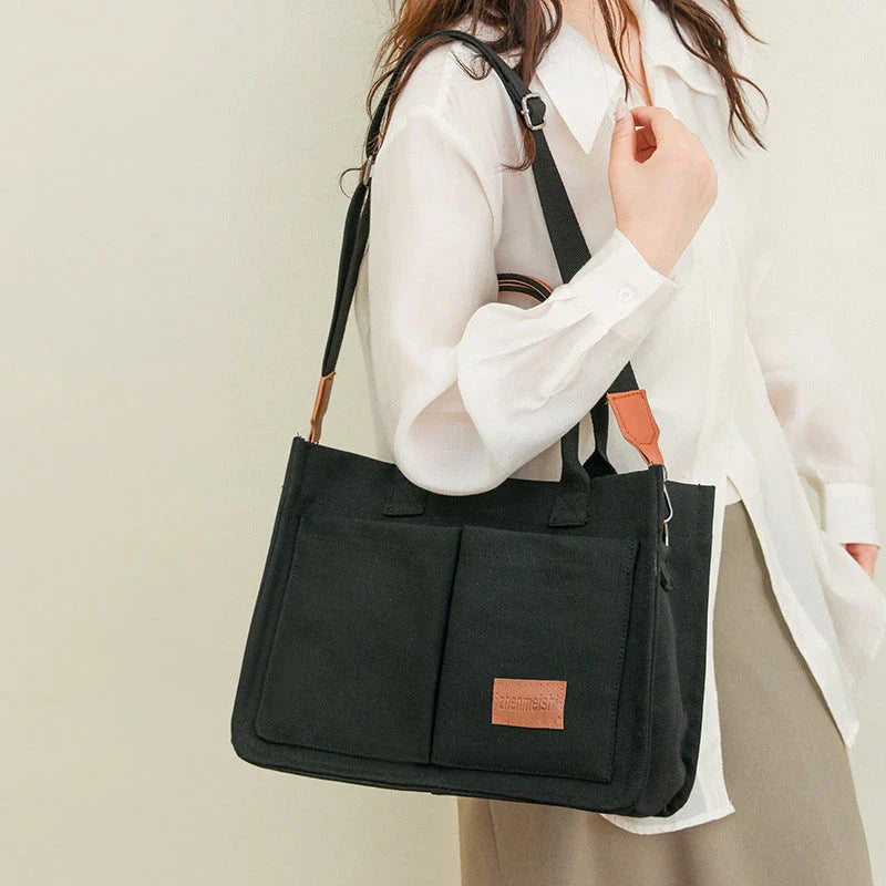 Premium canvas tote bag in multiple colors with adjustable shoulder strap and organizational pockets