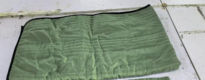 Lightweight plain coloured polyester summer quilt on a bed