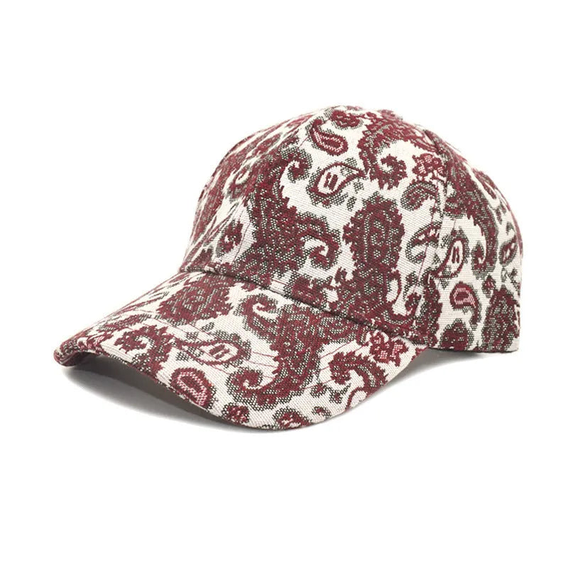 Blue polyester baseball cap with white paisley pattern print, showing dome crown style.