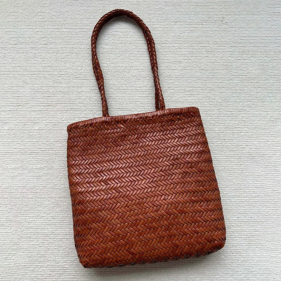 Brown handmade woven leather tote bag with three-dimensional pocket, showing 27cm height and textured cowhide construction