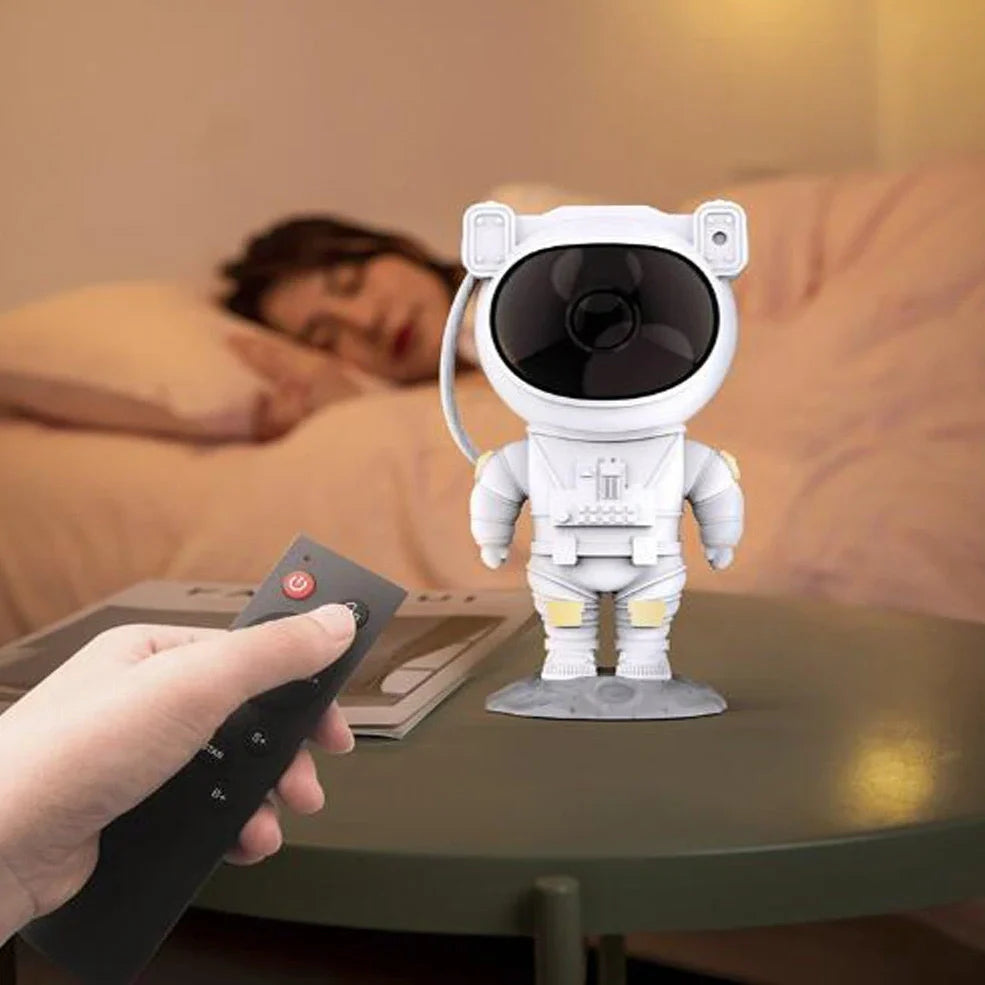 Astronaut-themed galaxy projector with adjustable nebula effects on table showing starry sky projection